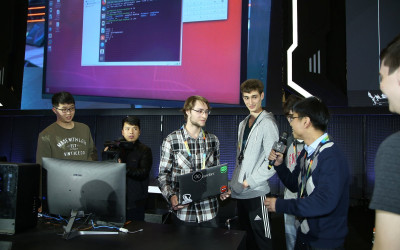 Students presenting with a large screen behind them